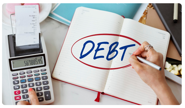 Notebook with the word 'Debt' circled beside a calculator and receipt